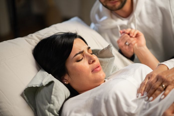 Concentrated woman giving birth at home