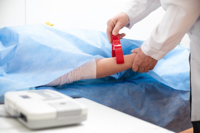 Doctor hands, Cardiotocograph device in a hospital to examine fetus heartbeat and make cardiogram.